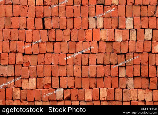 Brick Pattern. Stack of fresh processed bricks loosely stacked horizontally