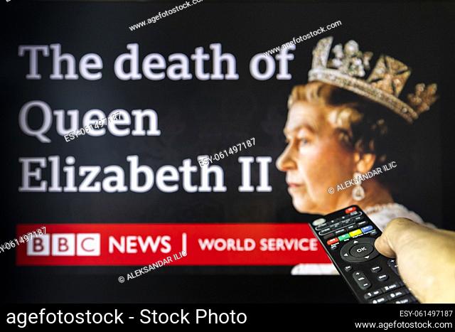 Belgrade, Serbia - September 12, 2022: The death of Queen Elizabeth II. Watching BBC news on tv about late Queen with remote controle in hand