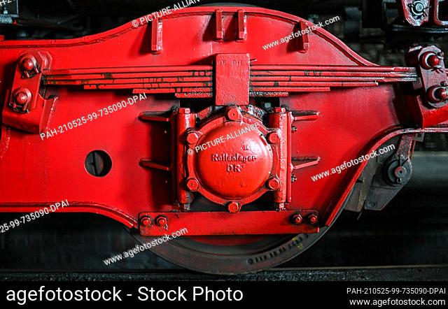 14 May 2021, Berlin: A detail showing the roller bearing on a class 52 freight locomotive in the locomotive shed of the Dampflokfreunde Berlin e.V