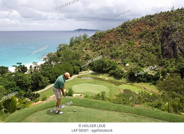 Golfer on Tee of Hole 15 at Lemuria Golf Course, Lemuria Resort of Praslin, Praslin Island, Seychelles