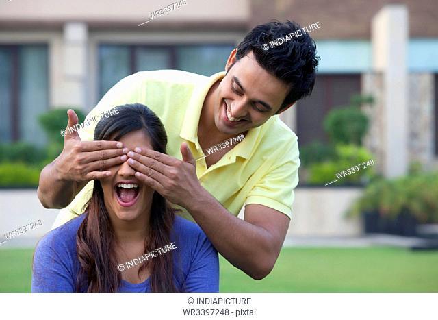 Man surprising his girlfriend