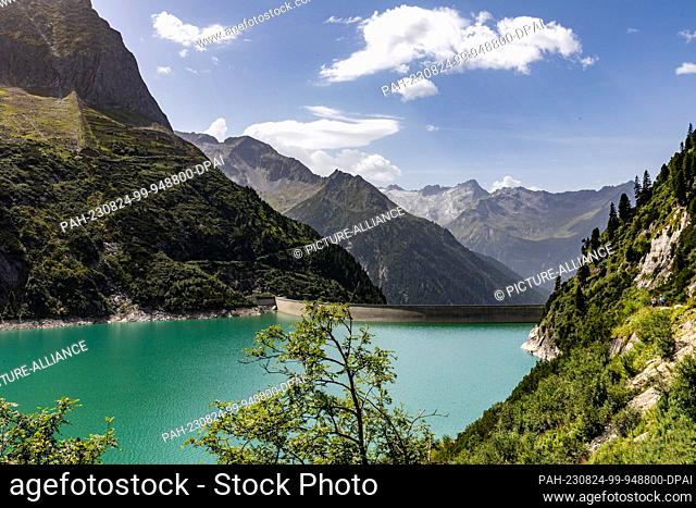 24 August 2023, Austria, Brandberg: The dam wall of the Zillergrund reservoir is 186 meters high and more than 500 meters wide