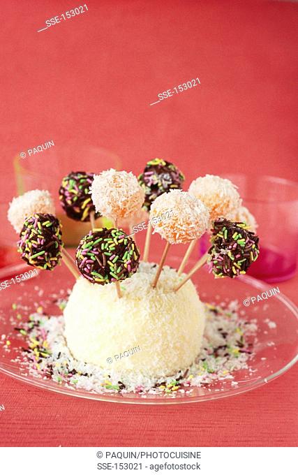 Iced Nutella lollipops and melon balls coated with grated coconut