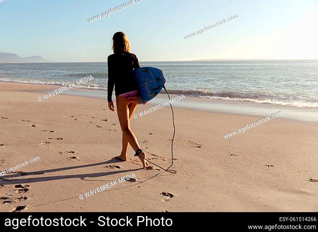 Caucasian woman during surf session at beach