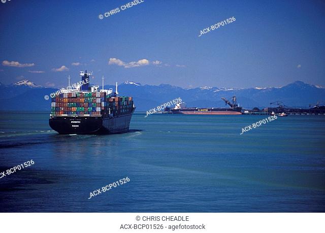 Cargo ship with coast mountains beyond, Tswassen, Vancouver, British Columbia, Canada