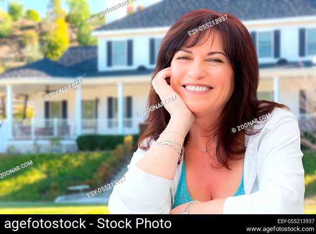 Attractive Middle Aged Woman Relaxing In Front Yard of Beautiful House