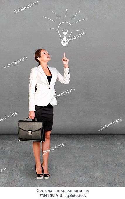 Business and education concept - young happy businesswoman with briefcase showing up