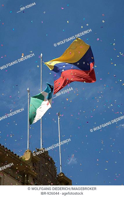 Confetti rain in front of Venezuelan flag, Merida, Venezuela, South America