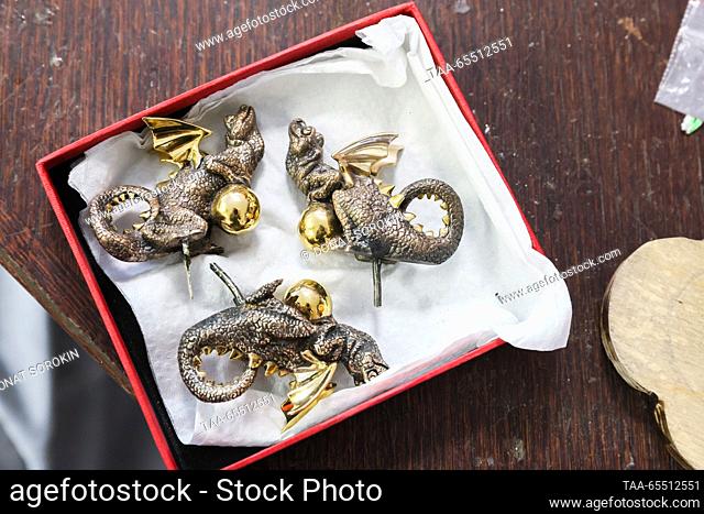 RUSSIA, YEKATERINBURG - DECEMBER 6, 2023: The Moiseikin jewellery house packages bronze dragons as New Year souvenirs; the Chinese calendar names 2024 the Year...
