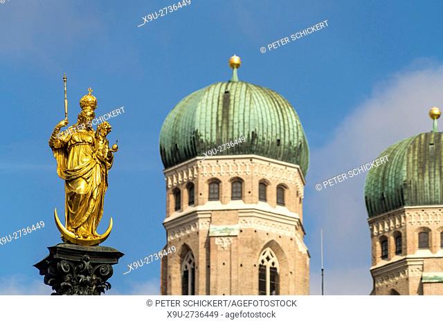 Virgin Mary atop the Mariensäule and the church towers of the Frauenkirche in Munich, Bavaria, Germany