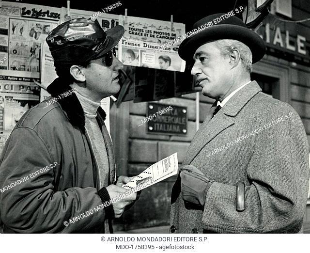 Alberto Sordi and Vittorio De Sica in Count Max. Italian actor and director Alberto Sordi holding a copy of Settimana Enigmistica and talking with Italian actor...