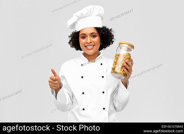 female chef with pasta in jar showing thumbs up