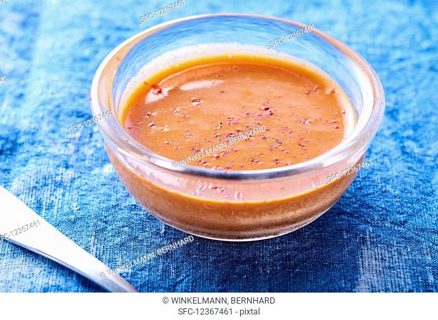 Pepper sauce in glass bowls on a blue background