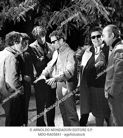 Italian writer and director Pier Paolo Pasolini talking to Italian actors Franco Citti and Ninetto Davoli and French actor Laurent Terzieff on the set of the...