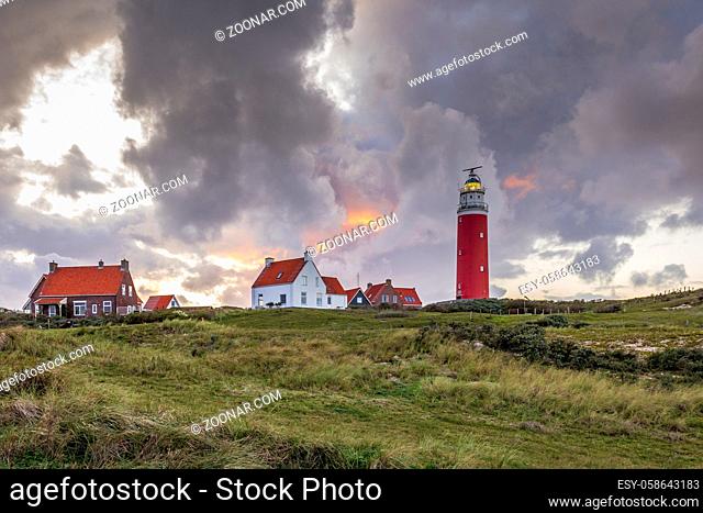 Landscape with scenic view of Lighthouse during sunset with rainy clouds at Waddenisland Texel, North Holland, Netherlands