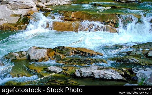 Fast mountain river flowig in cascade of waterfalls
