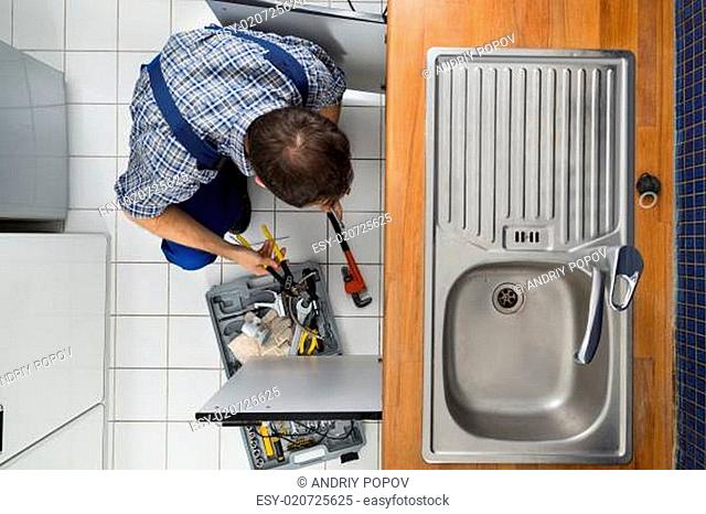 Plumber Examining Kitchen Sink