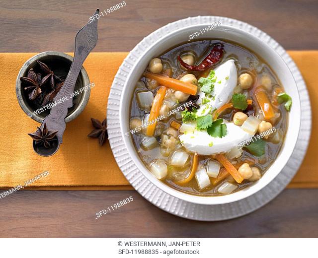 Oriental vegetable soup with chickpeas, coriander and cream cheese dumplings