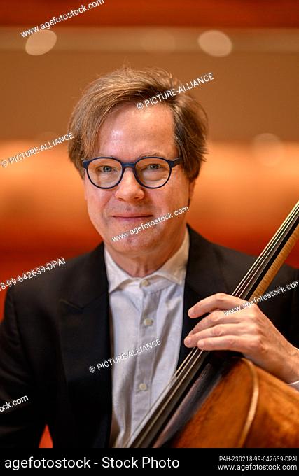 17 February 2023, Saxony, Dresden: Jan Vogler, musician and artistic director of the Dresden Music Festival, sits with his cello on stage at the Kulturpalast...