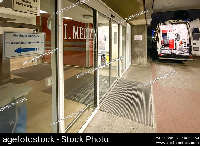 03 December 2020, Schleswig-Holstein, Kiel: An ambulance is parked in front of an entrance marked ""I.Medizin"" at the University Medical Center...