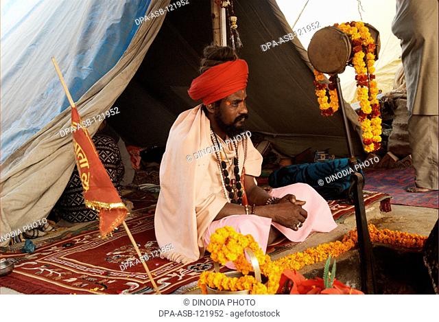 A naga sadhu from the Juna Akadha at his camp during the Ardh Kumbh Mela , , , India