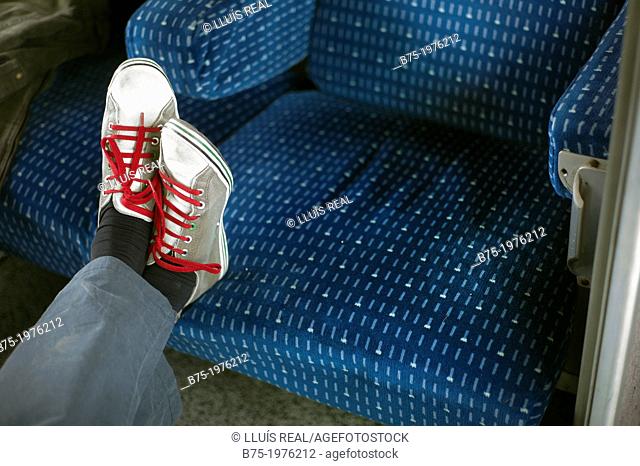 feet resting on a train chair