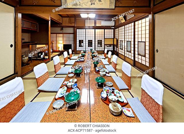 Traditional Japanese-style dining room for guests staying at Sumiyoshi Ryokan in Takayama, Japan. A ryokan is a type of traditional Japanese inn that originated...