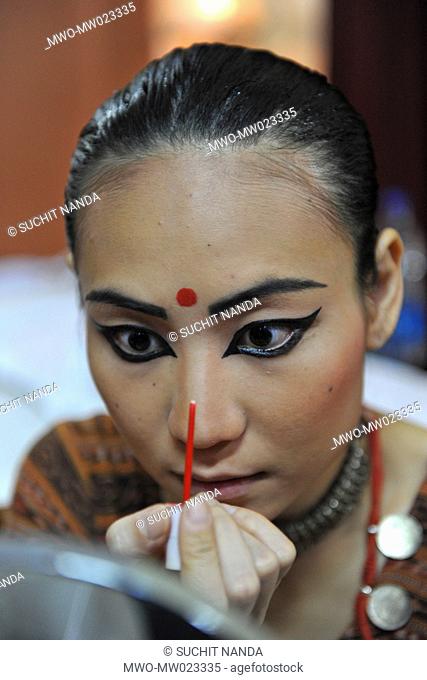 An Odissi dancer from Sutra Dance Academy, Malaysia, getting ready for performance, on the annual Konark Dance and Music Festival