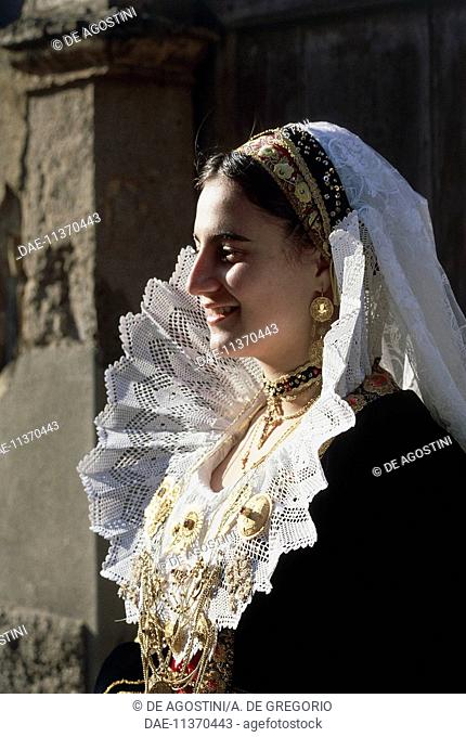 Young woman wearing the traditional costume with embroidery and gold filigree jewels, Quartucciu, Sardinia, Italy
