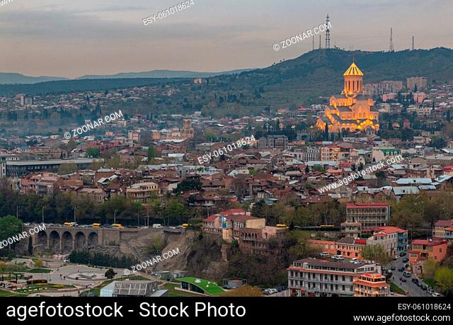 A picture of the Sameba Cathedral captured at sunset, in Tbilisi