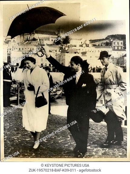 Feb. 18, 1957 - Queen And Duke In Portugal. Photo Shows: H.M. The Queen, protected by an umbrella, crosses the cobbled quay at Setubal, Portugal