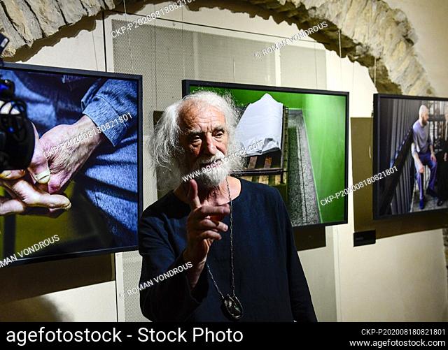 Czech photographer Jindrich Streit speaks and gestures during an opening of exhibition of his photos highlighting work of prison chaplains