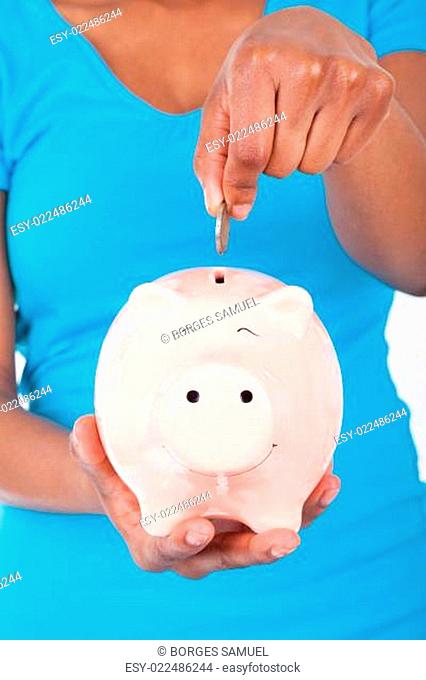 Black african american woman inseerting coin inside a smiling Pi
