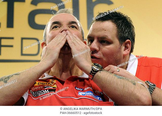 England's 16 time world champion Phil Taylor (L) and Adrian Lewis celebrate their victory over Belgium in the final at the World Cup of Darts at Alsterdorfer...