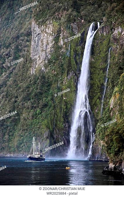 Water fall and boat in the Milford Sound