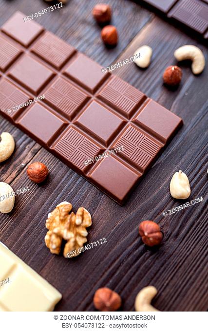 Delicious and sweet variety of chocolate on wooden background