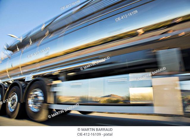Blurred view of stainless steel milk tanker on the move