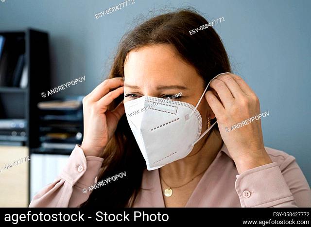 Woman Putting On Medical FFP2 Face Mask