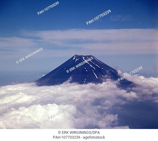 The summit of Fujijan volcano (Fuji) rises from a dense cloud cover. The volcano on Honshu Island is the highest mountain in Japan