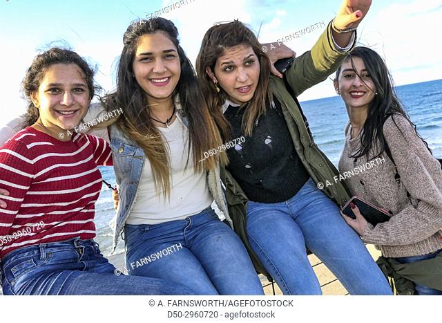 TEL AVIV ISRAEL Young Arab girls hamming it up for the photographer on the beach
