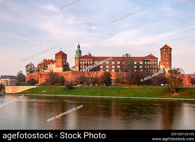 Wawel castle from opposite riverside upon Krakow old city center at sunset time in Krakow, Poland