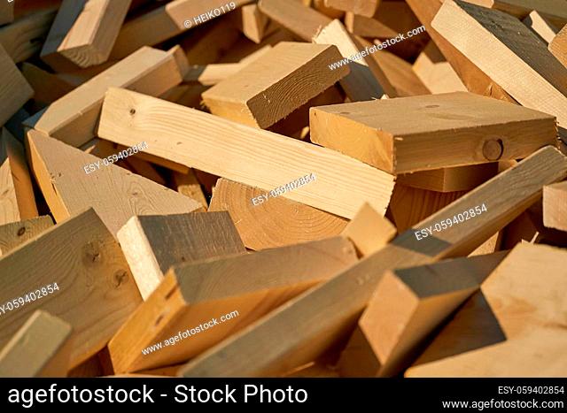 Remains of building material made of wood on the storage yard for processing in a pellet plant in the north of the city of Magdeburg in Germany