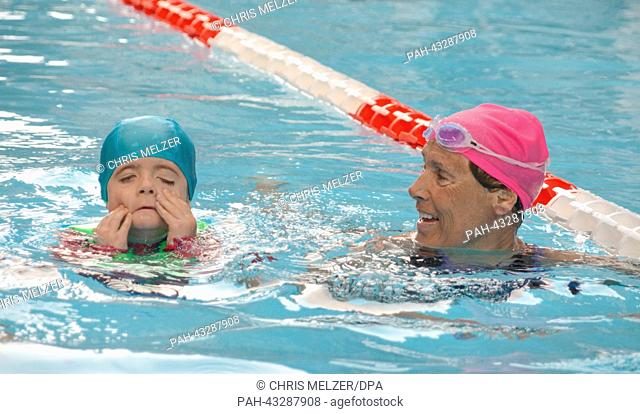 The extreme athlete Diana Nyad and three-year-old Harrison swim in a pool in New York, USA, 08 October 2013. By performing a 48-hour swim in the pool