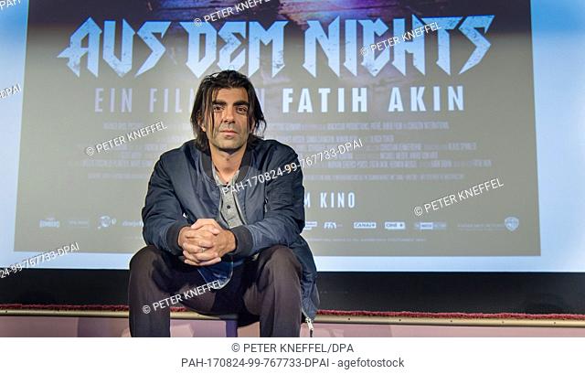 Film director Fatih Akin standing onstage in front of the poster of his film ""Out of Nothing"" in Munich, Germany, 24 August 2017