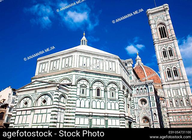 Baptistery of St. John, Giotto Campanile and Florence Cathedral consecrated in 1436 against a beautiful blue sky