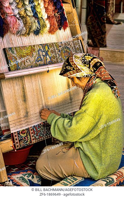 Portrait of woman making rugs by hand in Istanbul Turkey