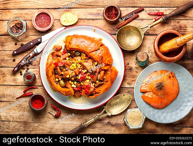 Pumpkin stuffed with meat, olives, corn and pepper. Mexican chicken