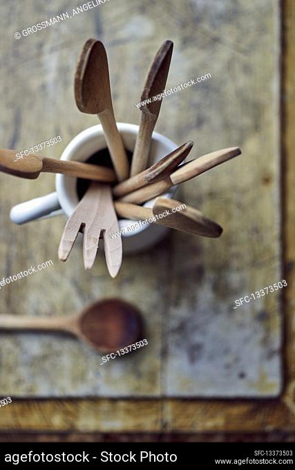 Wooden spoons and utensils in a porcelain jug