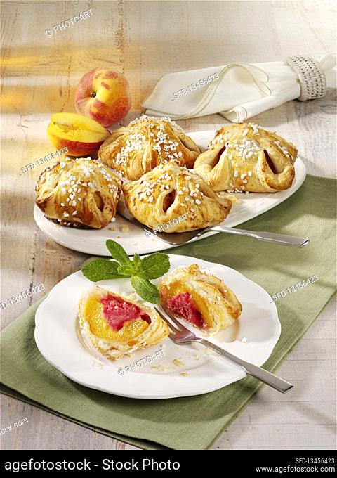 Peaches wrapped in puff pastry with raspberry jam and marzipan