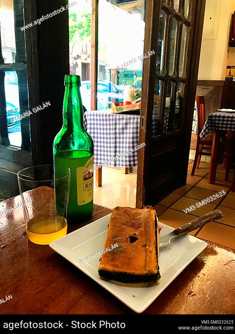 Piece of Asturian pie with glass of cider. Asturias, Spain
